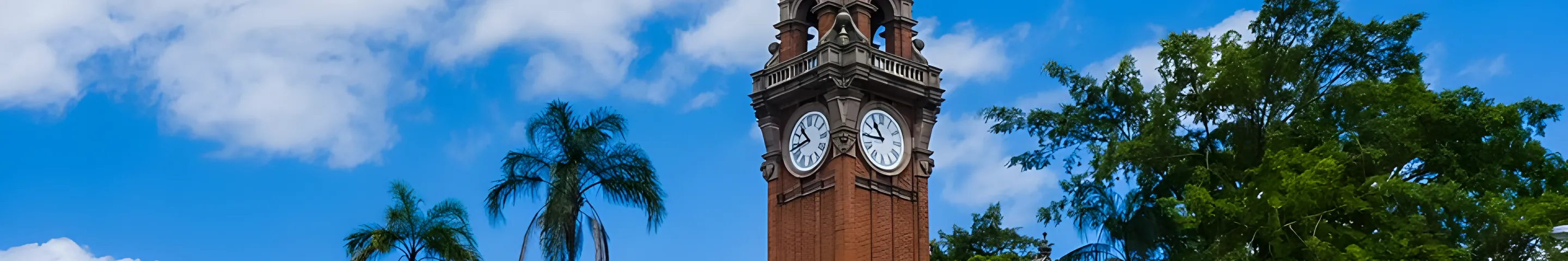 The old South Brisbane Town Hall clock tower under a blue sky